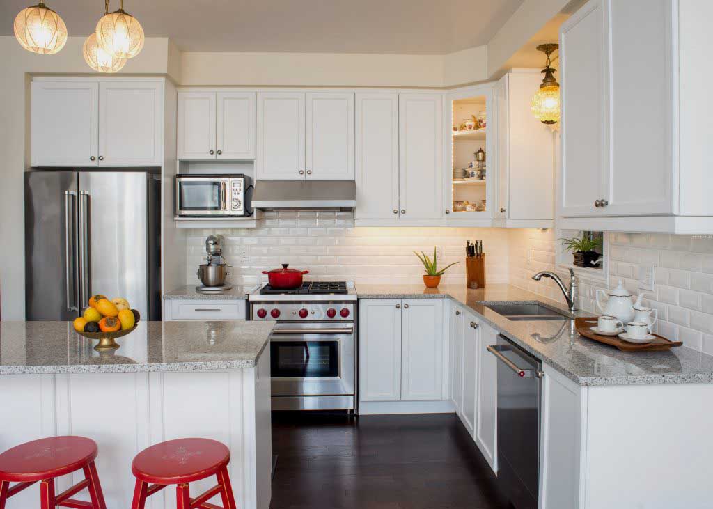 A kitchen with a stainless steel refrigerator with french doors.